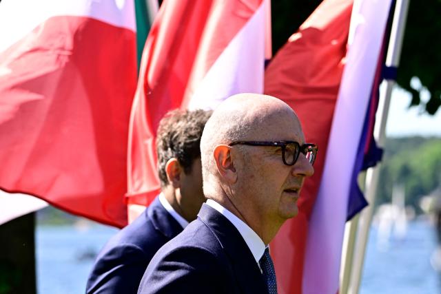 France's Economy, Finances and Industry Minister Roland Lescure is pictured on the background of waving flags prior to a meeting with the Finance Ministers of Germany, Spain, Italy, the Netherlands and Poland a at the Recreation Center of the German central bank (Deutsche Bundesbank) at Wannsee lake in Berlin on May 28, 2026. (Photo by Tobias SCHWARZ / AFP)