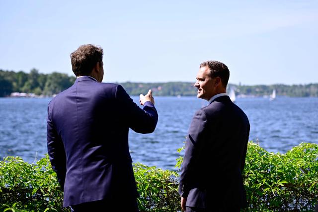 Germany's Finance Minister Lars Klingbeil (L) gestures as he chats with Netherlands' Minister of Finance Eelco Heinen by the water prior to a meeting at the Recreation Center of the German central bank (Deutsche Bundesbank) at Wannsee lake in Berlin on May 28, 2026. (Photo by Tobias SCHWARZ / AFP)