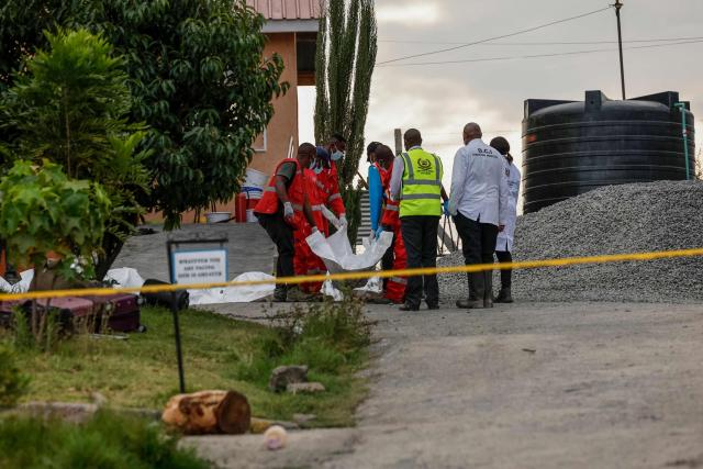 Kenya Red Cross workers retrieve one of the bodies at the Utumishi Girls Academy following the deadly fire in Gilgil, north of the capital Nairobi on May 28, 2026. A fire in a girls' dormitory in Kenya on May 28 killed 16 children and hospitalised 79 in the latest deadly blaze to hit a school in the east African country. The fire broke out shortly before 1:00 am local time at Utumishi Girls Academy in Nakuru County, around 120 kilometres (75 miles) north of the capital Nairobi, officials said. (Photo by SIMON MAINA / AFP)