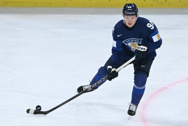 Finland's forward #94 Konsta Helenius controls the puck during the IIHF Ice Hockey Men's World Championship quarter-final match between Finland and Czech Republic at the Swiss Life Arena in Zurich, Switzerland on May 28, 2026. (Photo by SEBASTIEN BOZON / AFP)