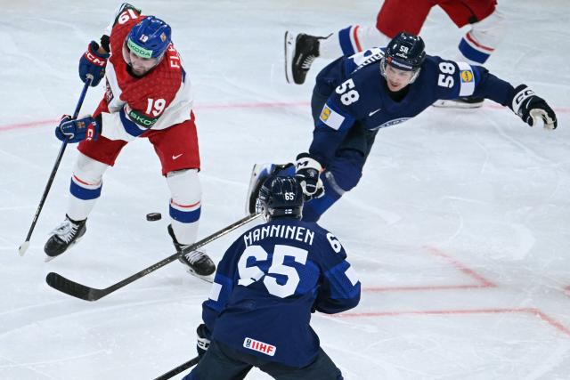 Czech Republic's forward #19 Jakub Flek (L) vies for the puck with Finland's forward #65 Sakari Manninen and Finland's defender #58 Urho Vaakanainen during the IIHF Ice Hockey Men's World Championship quarter-final match between Finland and Czech Republic at the Swiss Life Arena in Zurich, Switzerland on May 28, 2026. (Photo by SEBASTIEN BOZON / AFP)