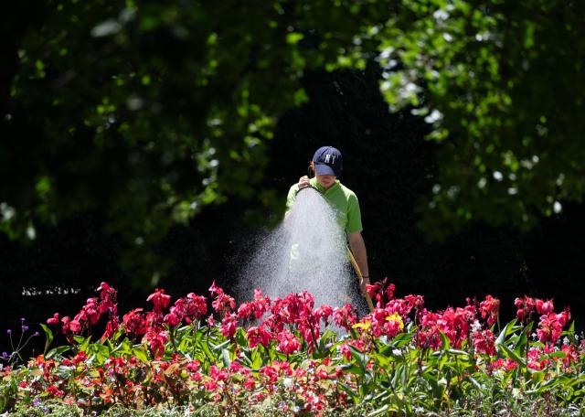 A city worker waters down flowers at the City park (Stadtpark)  on a sunny and hot day in Vienna, Austria, on May 28, 2026. Starting in late May, parts of Europe have been affected by heatwaves, breaking records in Spain, the United Kingdom, Germany, France, Ireland. (Photo by Joe Klamar / AFP)