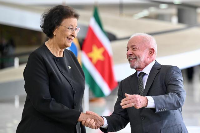 Suriname’s President Jennifer Geerlings-Simons (L) and Brazil’s President Luiz Inacio Lula da Silva shake hands during a meeting at Planalto Palace in Brasilia, on May 28, 2025. (Photo by Evaristo Sa / AFP)