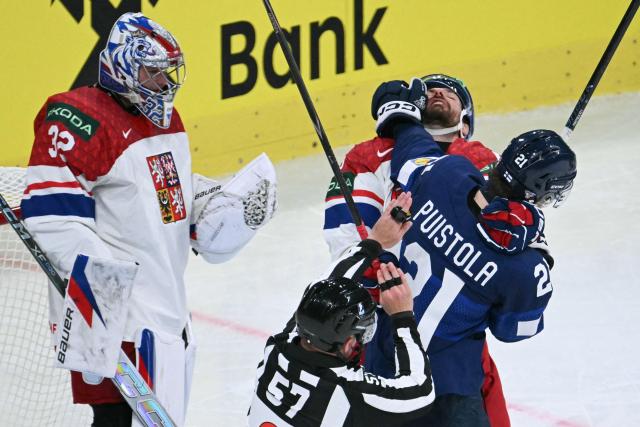 A referee interferes as Finland's forward #21 Patrik Puistola (R) fights with a Czech Republic player during the IIHF Ice Hockey Men's World Championship quarter-final match between Finland and Czech Republic at the Swiss Life Arena in Zurich, Switzerland on May 28, 2026. (Photo by SEBASTIEN BOZON / AFP)
