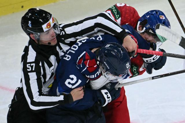 A referee interferes as Finland's forward #21 Patrik Puistola (C) fights with a Czech Republic player during the IIHF Ice Hockey Men's World Championship quarter-final match between Finland and Czech Republic at the Swiss Life Arena in Zurich, Switzerland on May 28, 2026. (Photo by SEBASTIEN BOZON / AFP)