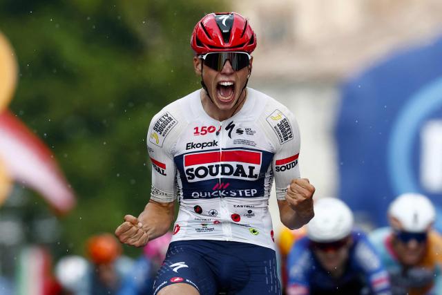 Soudal Quick-Step French rider Paul Magniercelebrates as he crosses the finish line to win the 18th stage of the Giro d'Italia 2026 - Tour of Italy cycling race between Fai della Paganella and Pieve di Soligo, Italy, on May 28, 2026. (Photo by Luca Bettini / AFP)