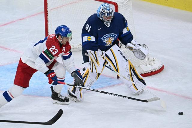 Czech Republic's forward #23 Lukas Sedlak and Finland's goalkeeper #31 Justus Annunen vie for the puck during the IIHF Ice Hockey Men's World Championship quarter-final match between Finland and Czech Republic at the Swiss Life Arena in Zurich, Switzerland on May 28, 2026. (Photo by SEBASTIEN BOZON / AFP)