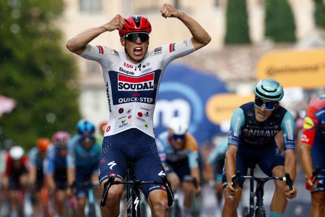 Soudal Quick-Step French rider Paul Magnier celebrates as he crosses the finish line to win the 18th stage of the Giro d'Italia 2026 - Tour of Italy cycling race between Fai della Paganella and Pieve di Soligo, Italy, on May 28, 2026. (Photo by Luca Bettini / AFP)