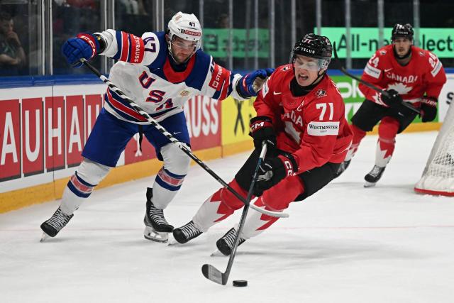 Canada’s forward #71 Macklin Celebrini (R) and USA's forward #47 Paul Cotter vie for the puck during the IIHF Ice Hockey Men's World Championship quarter-final match between Canada and USA in Fribourg, Switzerland on May 28, 2026. (Photo by Fabrice COFFRINI / AFP)
