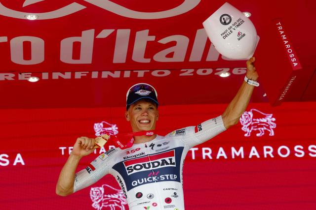 Soudal Quick-Step French rider Paul Magnier celebrates on the podium after winning the 18th stage of the Giro d'Italia 2026 - Tour of Italy cycling race between Fai della Paganella and Pieve di Soligo, Italy, on May 28, 2026. (Photo by Luca Bettini / AFP)