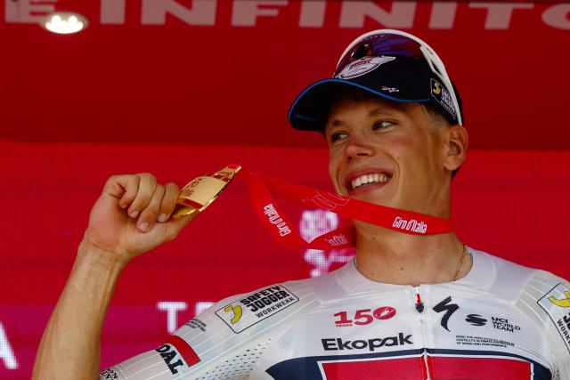 Soudal Quick-Step French rider Paul Magnier celebrates on the podium after winning the 18th stage of the Giro d'Italia 2026 - Tour of Italy cycling race between Fai della Paganella and Pieve di Soligo, Italy, on May 28, 2026. (Photo by Luca Bettini / AFP)