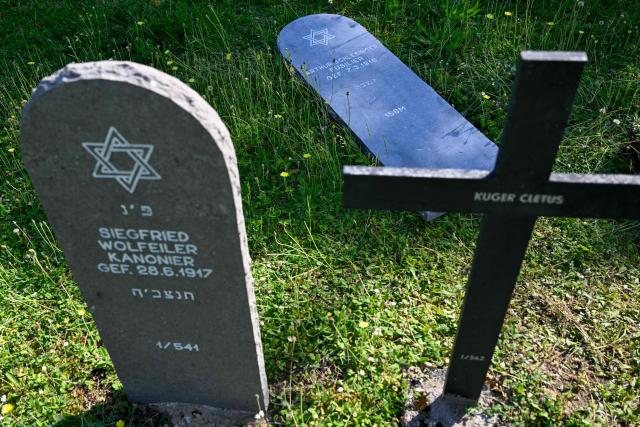 This photograph shows a gravestone of a Jewish German soldier (Up Right) lies on the ground as Members of "Service Entretien Sépultures Militaires Allemandes (SESMA)" of Volksbund Deutsche Kriegsgräberfürsorge (German War Graves Commission) replace gravestones of Jewish soldiers from the First World War at the Consenvoye German WWI cemetery (Verdun battlefield) to better reflect their religion, in Consenvoye, northeastern France,  on May 18, 2026. An unveiling ceremony will take place on June 3 , 2026. (Photo by Jean-Christophe Verhaegen / AFP)