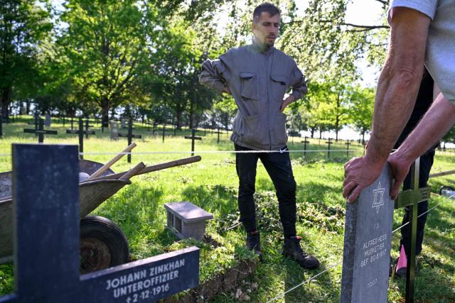 Members of "Service Entretien Sépultures Militaires Allemandes (SESMA)" of Volksbund Deutsche Kriegsgräberfürsorge (German War Graves Commission) replace gravestones of Jewish soldiers from the First World War at the Consenvoye German WWI cemetery (Verdun battlefield) to better reflect their religion, in Consenvoye, northeastern France, on May 18, 2026. An unveiling ceremony will take place on June 3 , 2026. (Photo by Jean-Christophe Verhaegen / AFP)
