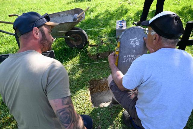 Members of "Service Entretien Sépultures Militaires Allemandes (SESMA)" of Volksbund Deutsche Kriegsgräberfürsorge (German War Graves Commission) replace gravestones of Jewish soldiers from the First World War at the Consenvoye German WWI cemetery (Verdun battlefield) to better reflect their religion, in Consenvoye, northeastern France, on May 18, 2026. An unveiling ceremony will take place on June 3 , 2026. (Photo by Jean-Christophe Verhaegen / AFP)