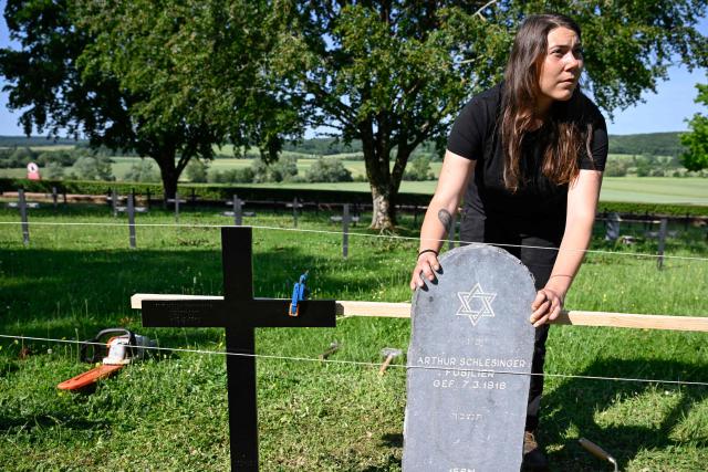 Member of "Service Entretien Sépultures Militaires Allemandes (SESMA)" of the Volksbund Deutsche Kriegsgräberfürsorge (German War Graves Commission) replaces the gravestones of Jewish soldiers from the First World War at the Consenvoye German WWI cemetery (Verdun battlefield) to better reflect their religion, in Consenvoye, northeastern France, on May 18, 2026. An unveiling ceremony will take place on June 3 , 2026. (Photo by Jean-Christophe Verhaegen / AFP)