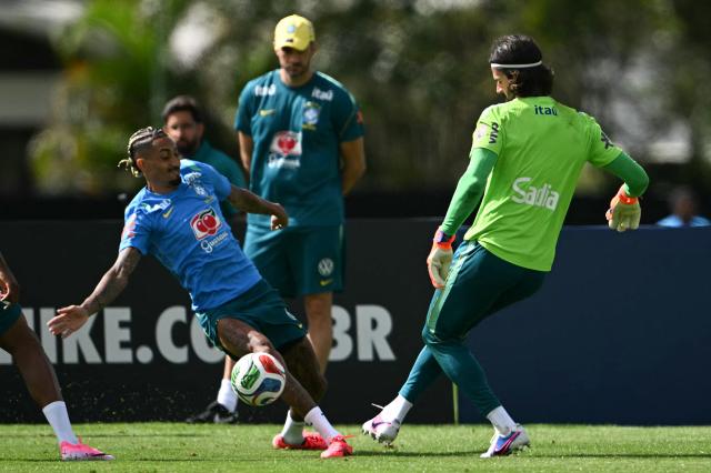 Brazil's forward Raphinha (L) and goalkeeper Alisson fight for the ball during a training session at the Granja Comary training center in Teresopolis, Rio de Janeiro, Brazil, on May 28, 2026, ahead of the FIFA World Cup 2026. (Photo by MAURO PIMENTEL / AFP)