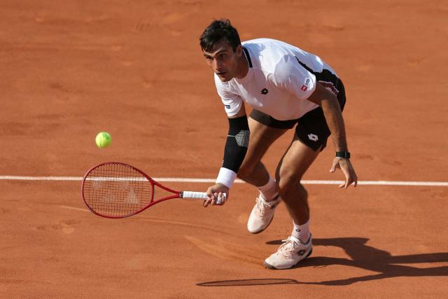 Argentina's Roman Andres Burruchaga plays a forehand return to Canada's Felix Auger-Aliassime during their men's singles match on day 5 of the French Open tennis tournament on Court Simonne-Mathieu at the Roland-Garros Complex in Paris on May 28, 2026. (Photo by Thomas SAMSON / AFP)