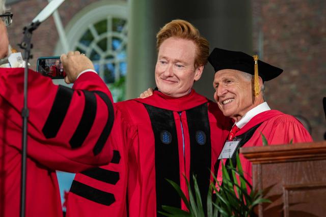 US comedian Conan O'Brien (C), commencement speaker, takes photos with students and faculty in Harvard Yard during the 175th Commencement ceremony at Harvard University in Cambridge, Massachusetts on May 28, 2026. (Photo by Joseph Prezioso / AFP)