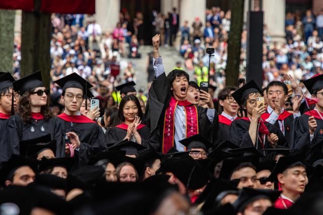 Student graduates cheer as degrees are conferred onto them in Harvard Yard during the 175th Commencement ceremony at Harvard University in Cambridge, Massachusetts, on May 28, 2026. (Photo by Joseph Prezioso / AFP)