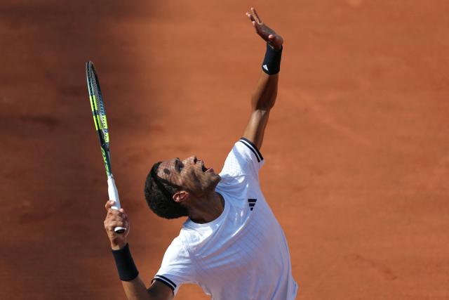 Canada's Felix Auger-Aliassime serves to Argentina's Roman Andres Burruchaga during their men's singles match on day 5 of the French Open tennis tournament on Court Simonne-Mathieu at the Roland-Garros Complex in Paris on May 28, 2026. (Photo by Thomas SAMSON / AFP)