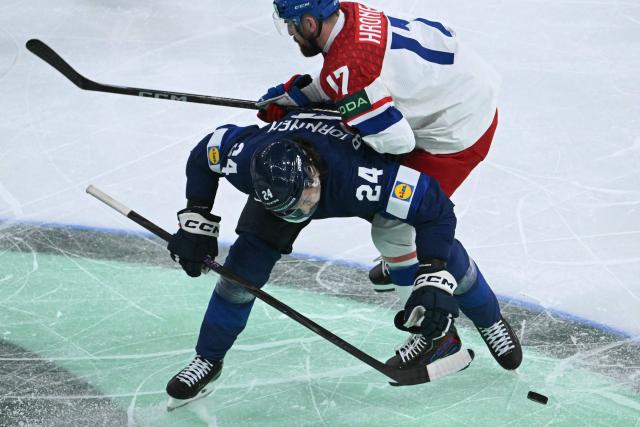 Finland's forward #24 Hannes Bjorninen and Czech Republic's defender #17 Filip Hronek vie for the puck during the IIHF Ice Hockey Men's World Championship quarter-final match between Finland and Czech Republic at the Swiss Life Arena in Zurich, Switzerland on May 28, 2026. (Photo by SEBASTIEN BOZON / AFP)