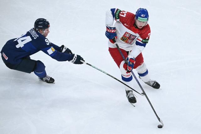 Finland's forward #94 Konsta Helenius and Czech Republic's defender #27 Marek Alscher vie for the puck during the IIHF Ice Hockey Men's World Championship quarter-final match between Finland and Czech Republic at the Swiss Life Arena in Zurich, Switzerland on May 28, 2026. (Photo by SEBASTIEN BOZON / AFP)