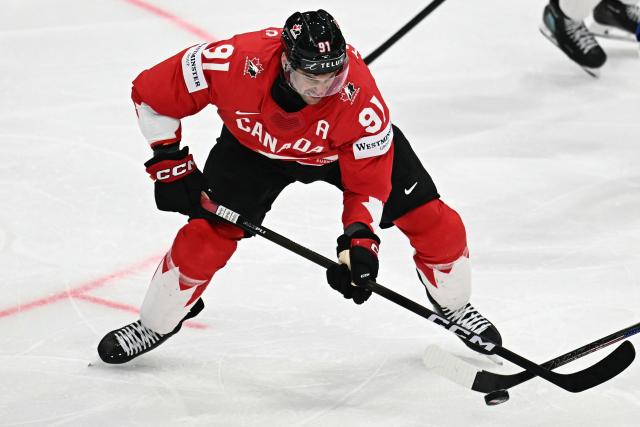 Canada’s forward #91 John Tavares fights for the puck during the IIHF Ice Hockey Men's World Championship quarter-final match between Canada and USA in Fribourg, Switzerland on May 28, 2026. (Photo by Fabrice COFFRINI / AFP)