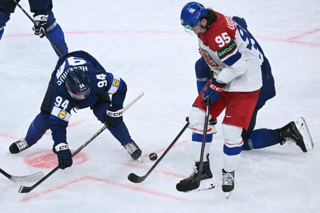Finland's forward #94 Konsta Helenius and Czech Republic's forward #95 Daniel Vozenilek vie for the puck during the IIHF Ice Hockey Men's World Championship quarter-final match between Finland and Czech Republic at the Swiss Life Arena in Zurich, Switzerland on May 28, 2026. (Photo by SEBASTIEN BOZON / AFP)