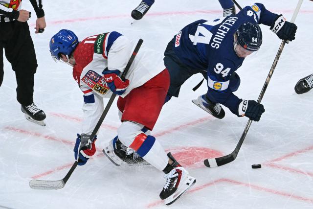 Czech Republic's forward #11 Matyas Melovsky and Finland's forward #94 Konsta Helenius vie for the puck during the IIHF Ice Hockey Men's World Championship quarter-final match between Finland and Czech Republic at the Swiss Life Arena in Zurich, Switzerland on May 28, 2026. (Photo by SEBASTIEN BOZON / AFP)