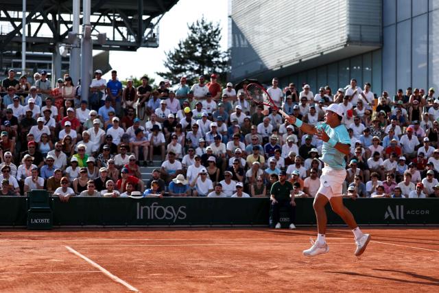 US Brandon Nakashima plays a forehand return to France's Luca Van Assche during their men's singles match on day 5 of the French Open tennis tournament at the Roland-Garros Complex in Paris on May 28, 2026. (Photo by Anne-Christine POUJOULAT / AFP)
