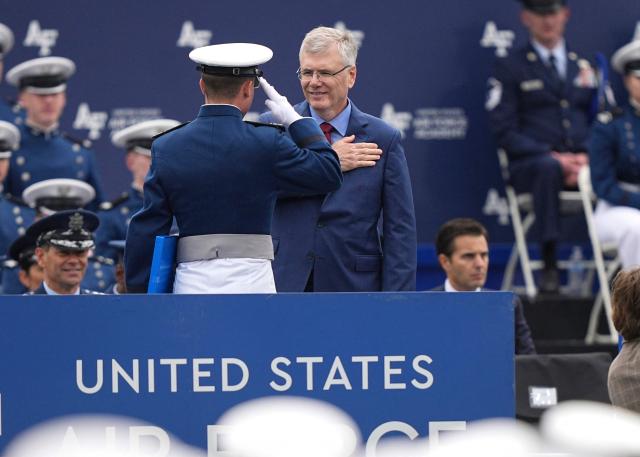 A graduating cadet (L), salutes US Secretary of the Air Force Troy Meink  during the 2026 graduation ceremony at the US Air Force Academy in Colorado Springs, Colorado, on May 28, 2026. (Photo by Matt Rourke / POOL / AFP)