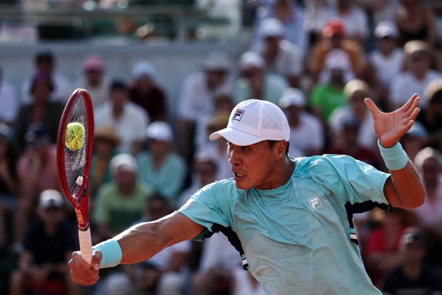 US Brandon Nakashima plays a backhand return to France's Luca Van Assche during their men's singles match on day 5 of the French Open tennis tournament at the Roland-Garros Complex in Paris on May 28, 2026. (Photo by Anne-Christine POUJOULAT / AFP)