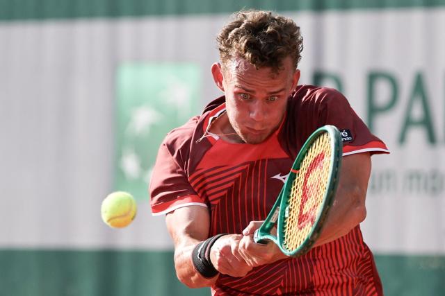 France's Luca Van Assche plays a backhand return to US Brandon Nakashima during their men's singles match on day 5 of the French Open tennis tournament at the Roland-Garros Complex in Paris on May 28, 2026. (Photo by Anne-Christine POUJOULAT / AFP)
