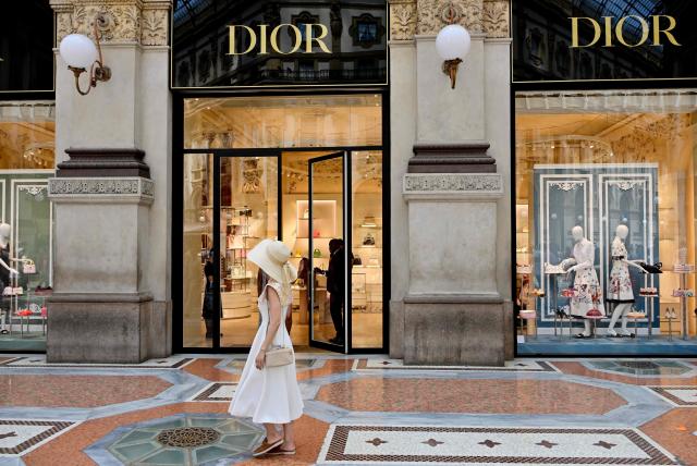 A tourist stroll in front of Dior flagship store in Galleria Vittorio Emanuele II downtown Milan on May 28, 2026.  (Photo by Stefano RELLANDINI / AFP)