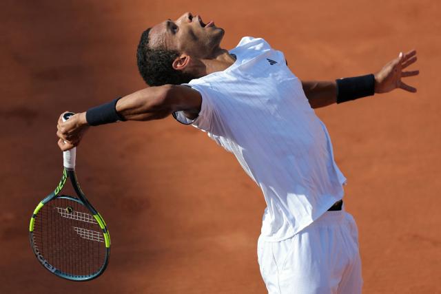 Canada's Felix Auger-Aliassime serves to Argentina's Roman Andres Burruchaga during their men's singles match on day 5 of the French Open tennis tournament on Court Simonne-Mathieu at the Roland-Garros Complex in Paris on May 28, 2026. (Photo by Thomas SAMSON / AFP)