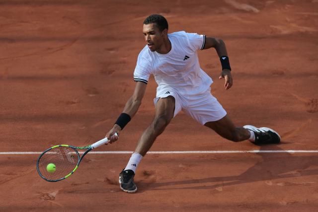 Canada's Felix Auger-Aliassime plays a forehand return to Argentina's Roman Andres Burruchaga during their men's singles match on day 5 of the French Open tennis tournament on Court Simonne-Mathieu at the Roland-Garros Complex in Paris on May 28, 2026. (Photo by Thomas SAMSON / AFP)