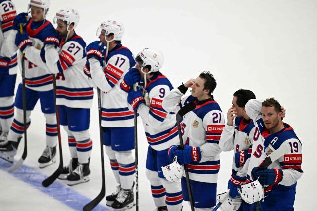 USA's forward #19 Matthew Tkachuk (R) reacts with teammates after the IIHF Ice Hockey Men's World Championship quarter-final match between Canada and USA in Fribourg, Switzerland on May 28, 2026. (Photo by Fabrice COFFRINI / AFP)
