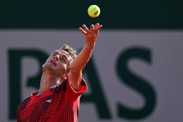 France's Luca Van Assche serves to US Brandon Nakashima during their men's singles match on day 5 of the French Open tennis tournament at the Roland-Garros Complex in Paris on May 28, 2026. (Photo by Anne-Christine POUJOULAT / AFP)