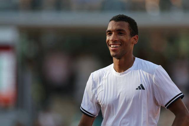 Argentina's Roman Andres Burruchaga smiles as he plays against Canada's Felix Auger-Aliassime during their men's singles match on day 5 of the French Open tennis tournament on Court Simonne-Mathieu at the Roland-Garros Complex in Paris on May 28, 2026. (Photo by Thomas SAMSON / AFP)