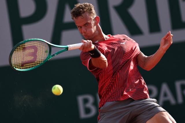 France's Luca Van Assche plays a forehand return to US Brandon Nakashima during their men's singles match on day 5 of the French Open tennis tournament at the Roland-Garros Complex in Paris on May 28, 2026. (Photo by Anne-Christine POUJOULAT / AFP)