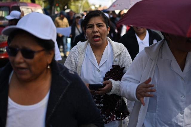 Doctors, nurses and other healthcare workers protest against roadblocks and access blockades to the city carried out by demonstrators opposing Bolivian President Rodrigo Paz, denouncing that shortages of food, medicines and oxygen are affecting patient care, in La Paz, Bolivia, on May 28, 2026. (Photo by Marvin RECINOS / AFP)