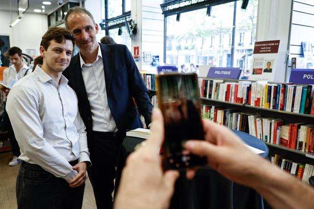 Place publique's centre-left party leader and France's MEP Raphael Glucksmann poses for photographs with attendees during a book-signing session of his newly released book titled "Nous Avons Encore Envie" (We still want to) at the Eyrolles publisher bookshop in Paris on May 28, 2026. (Photo by SIMON WOHLFAHRT / AFP)