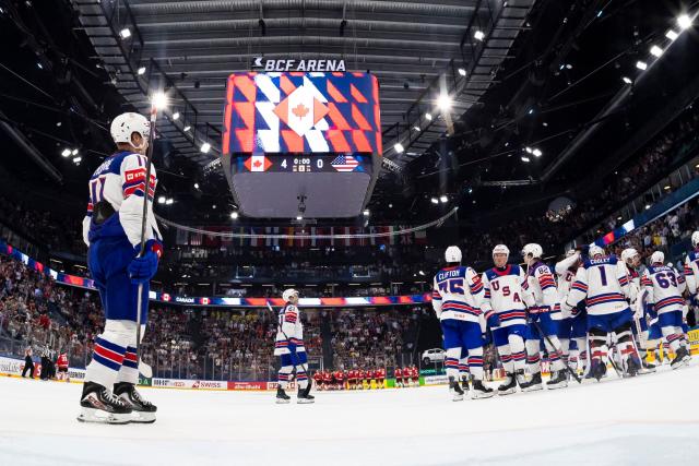 USA's players react after their team's defeat in the IIHF Ice Hockey Men's World Championship quarter-final match between Canada and USA in Fribourg, Switzerland on May 28, 2026. (Photo by ANTHONY ANEX / POOL / AFP)