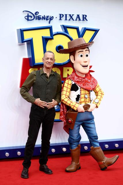 US actor Tom Hanks poses with his character Woody, upon arrival to attend the red carpet for the UK launch event of the film 'Toy Story 5' in London on May 28, 2026. (Photo by Henry NICHOLLS / AFP)