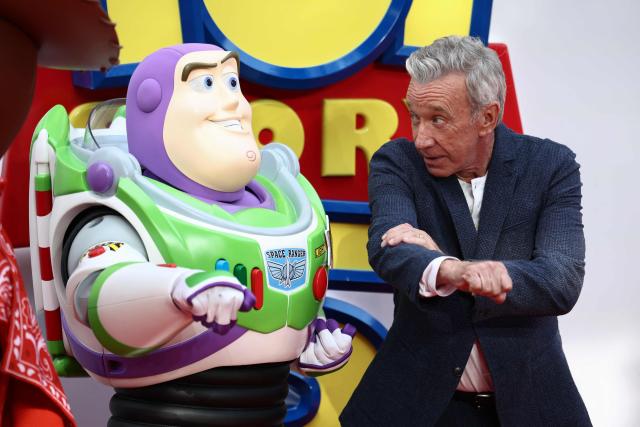 US actor Tim Allen poses with his character Buzz Lightyear, upon arrival to attend the red carpet for the UK launch event of the film 'Toy Story 5' in London on May 28, 2026. (Photo by Henry NICHOLLS / AFP)