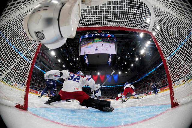 Czech Republic's goalkeeper #32 Josef Korenar dives for the puck during the IIHF Ice Hockey Men's World Championship quarter-final match between Finland and Czech Republic at the Swiss Life Arena in Zurich, Switzerland on May 28, 2026. (Photo by Claudio Thoma / POOL / AFP)