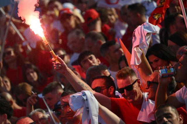 A supporter of Malta’s Labour Party (PL) lights a flare as he takes part in an election campaign rally in the capital city of Valletta on May 28, 2026. Malta's general elections will be held on May 30 to elect all members of the House of Representatives. (Photo by Alberto PIZZOLI / AFP)