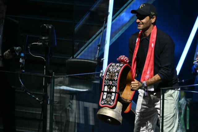 Swiss former tennis player Roger Federer rings a bell to start the IIHF Ice Hockey Men's World Championship quarter-final match between Switzerland and Sweden at the Swiss Life Arena in Zurich, on May 28, 2026. (Photo by SEBASTIEN BOZON / AFP)