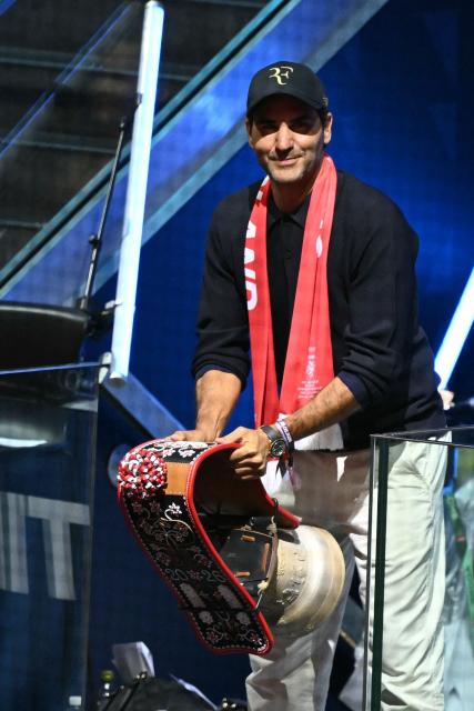 Swiss former tennis player Roger Federer rings a bell to start the IIHF Ice Hockey Men's World Championship quarter-final match between Switzerland and Sweden at the Swiss Life Arena in Zurich, on May 28, 2026. (Photo by SEBASTIEN BOZON / AFP)