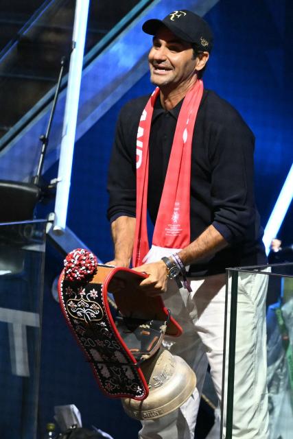 Swiss former tennis player Roger Federer rings a bell to start the IIHF Ice Hockey Men's World Championship quarter-final match between Switzerland and Sweden at the Swiss Life Arena in Zurich, on May 28, 2026. (Photo by SEBASTIEN BOZON / AFP)